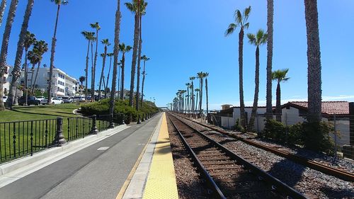 Railroad tracks in city against clear sky