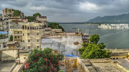 High angle view of buildings against cloudy sky