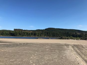 Scenic view of land against clear blue sky