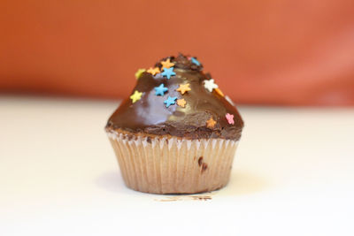 Close-up of cupcake with star shape decoration on table