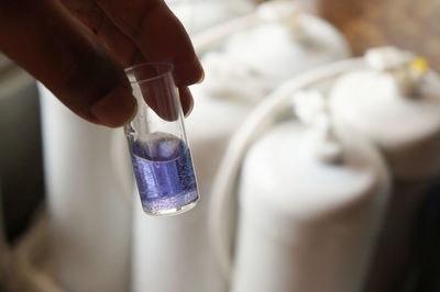 Close-up of hand holding bottle