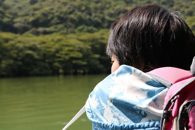 Side view of woman looking at lake