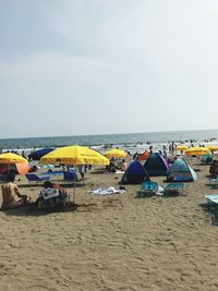 People on beach against sky