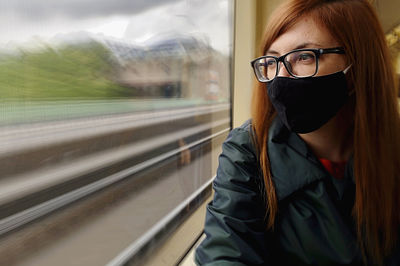 Woman looking through train window