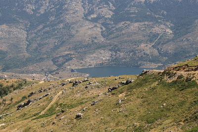 High angle view of land and sea against mountains