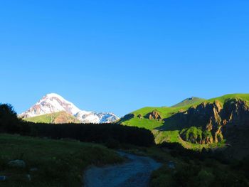 Scenic view of mountains against clear blue sky