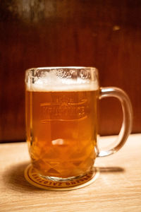 Close-up of beer glass on table