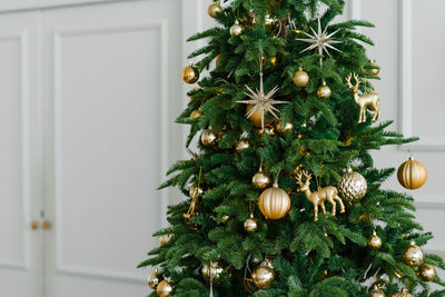 Close-up of golden balls and a star on the christmas tree. copy space