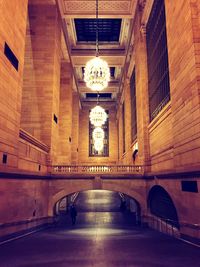 Low angle view of chandelier hanging on subway ceiling