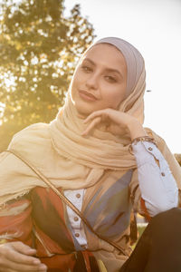 Portrait of smiling young woman wearing hijab