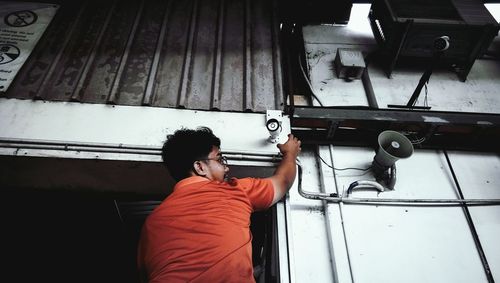 Man repairing security camera