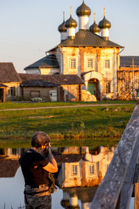Side view of man looking through window