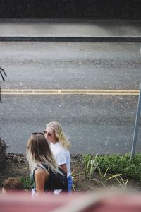 Rear view of girl walking on road