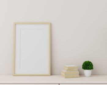 Blank picture frame against white wall