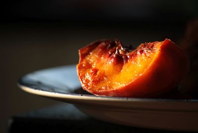 Close-up of fresh peach in plate on table