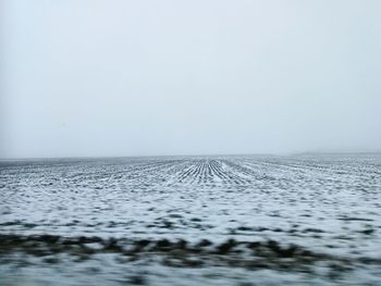 Scenic view of sea against clear sky during winter