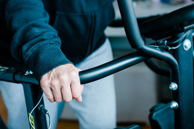 Close-up of man holding bicycle