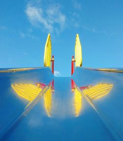 Flag on boat against blue sky