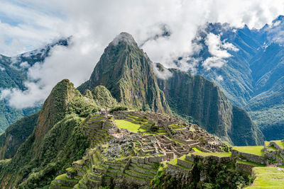 High angle view of rock formations against cloudy sky at machu picchu