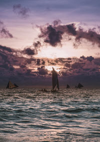 Scenic photo of sailboats in the ocean on the sunset. picturesque picture of two sailing ships 