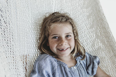 Portrait of smiling school-aged girl with braid in her hair