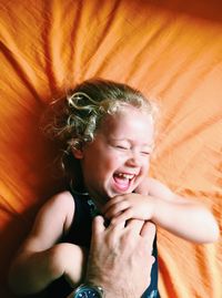 Close-up of man tickling young girl