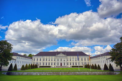 Buildings against sky with lawn in foreground