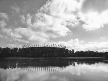 Arch bridge over lake against sky