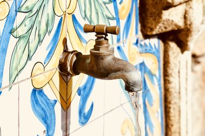 Close-up of faucet against wall