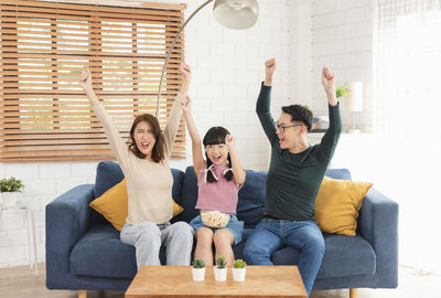 Young couple sitting on sofa at home