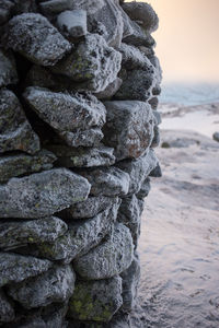 Stack of rocks on beach against sky