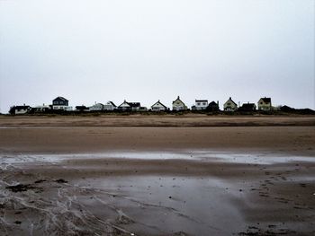 Scenic view of beach against clear sky