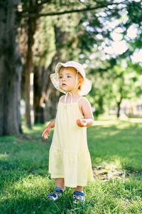 Cute boy standing on field