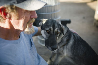 High angle view of man with dog sitting outdoors