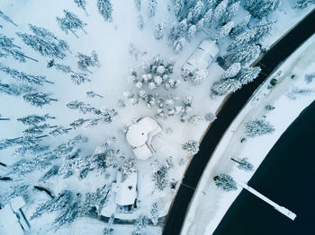 Close-up of snow on window against sky