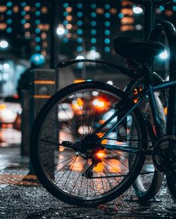 Close-up of bicycle parked on street at night