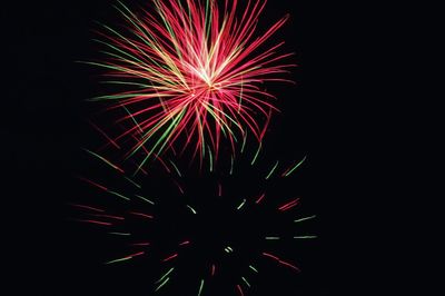 Low angle view of firework display at night