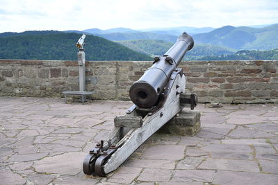 Coin-operated binoculars on mountain against sky