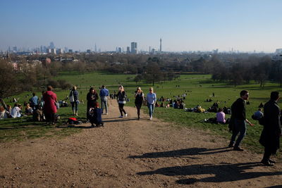 People on field against clear sky