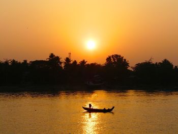 Boat sailing in sea during sunset