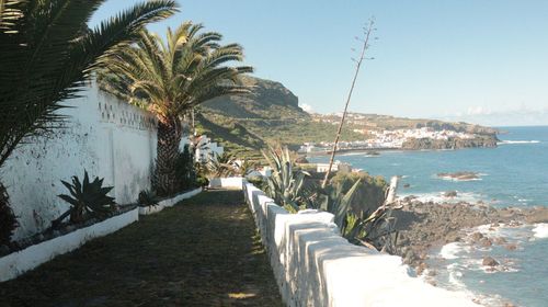 Footpath by sea against sky