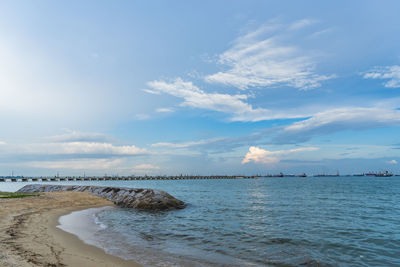 View of beach against cloudy sky
