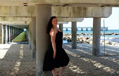 Portrait of woman standing at beach