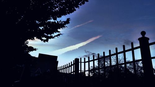 Low angle view of silhouette trees against sky