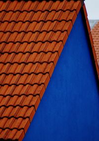 Low angle view of roof of building against blue sky