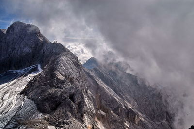 Scenic view of mountains against cloudy sky