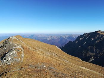 Scenic view of mountains against clear blue sky