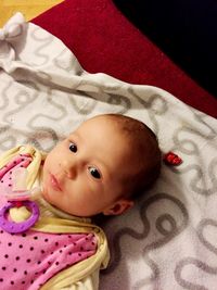 Close-up of young woman lying on bed