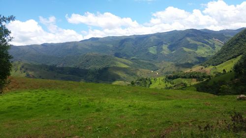 Scenic view of mountains against cloudy sky