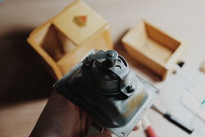 Close-up of hand holding metallic equipment